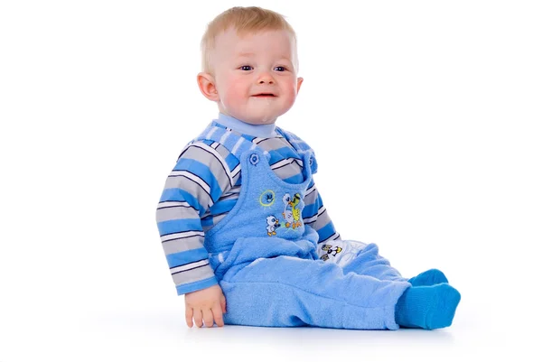 Ett litet barn sitter och skrattar — Stockfoto