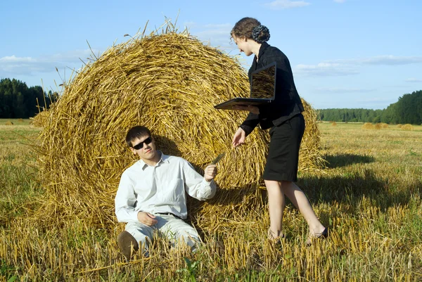Colleagues in the nature near the haystacks — Stock Photo, Image
