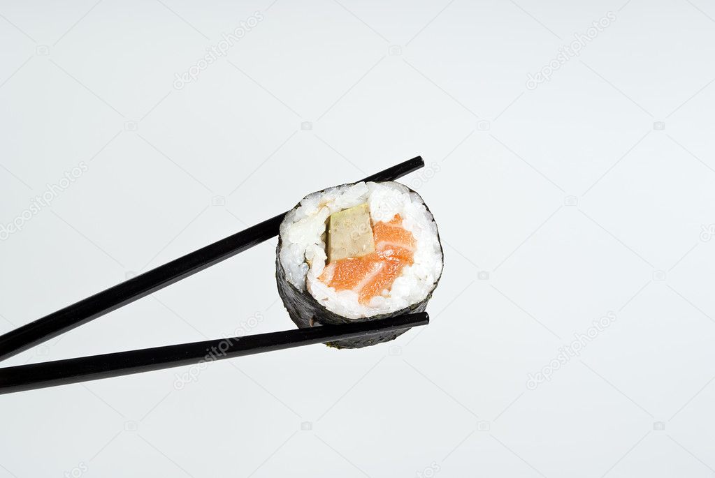 Sushi on a stick against a background of gray