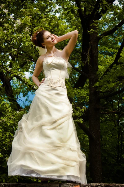 Beautiful bride with green foliage — Stock Photo, Image