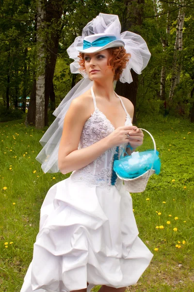 Beautiful bride with a blue trail — Stock Photo, Image