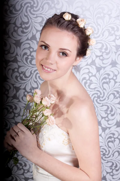 stock image Cute girl in a wedding dress with a bouquet