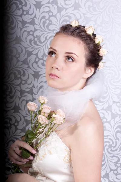 Милая девушка в свадебном платье с букетом — стоковое фото