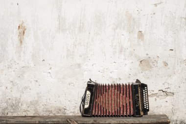 Wall and accordion on the bench background clipart