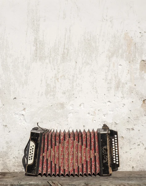 Stock image Wall and accordion on the bench background