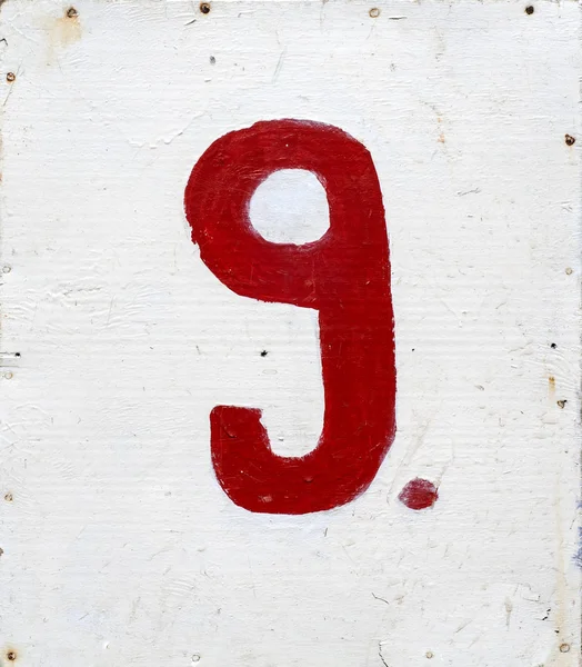 Número nueve sobre fondo de madera contrachapada blanca — Foto de Stock