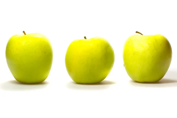 Три желто-зеленых яблока на белом фоне . — стоковое фото