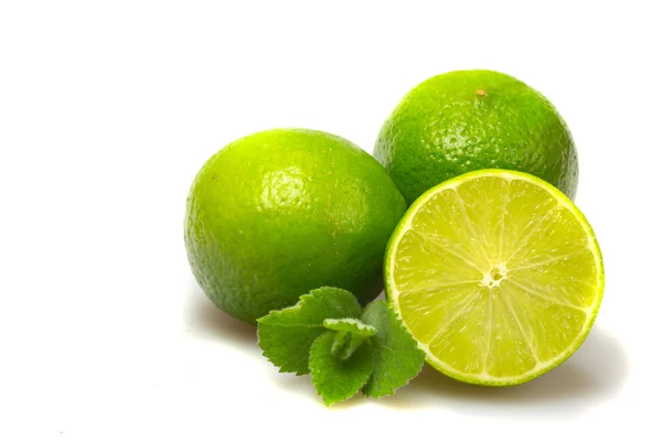 stock image Limes with mint leaves on white.