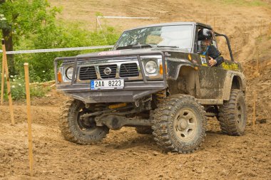 Off-road car in difficult muddy terrain clipart