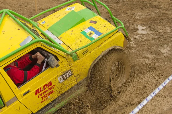 Detailed view of the yellow car in a mud