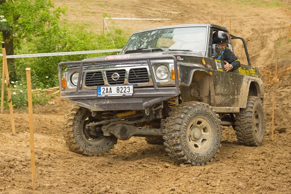 Off-road car in difficult muddy terrain