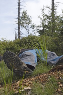 Hiker taking a rest. clipart