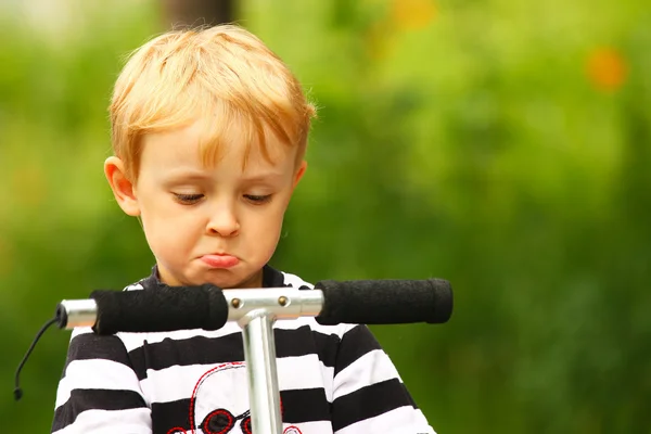 Angry kid on a scooter — Stock Photo, Image