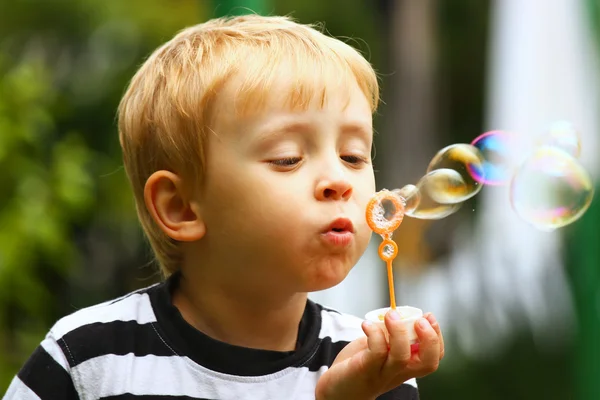 Blond boy and soap bubbles — Stock Photo, Image