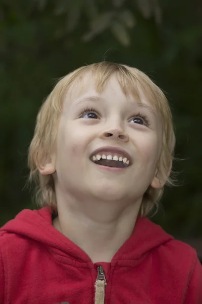 Lächelnder blonder Junge blickt auf. — Stockfoto
