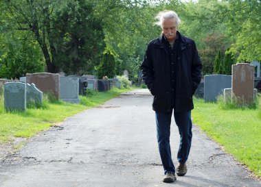 Man walking in cemetery clipart