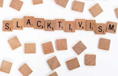 Scrabble tiles spell out 'Slacktivism' clipart