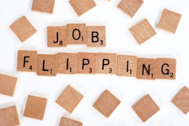 Scrabble tiles spell out 'Job Flipping' clipart