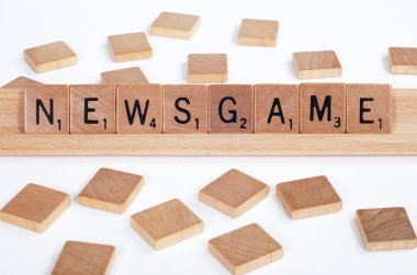 Scrabble tiles spell out 'Newsgame' clipart