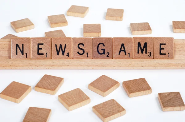 Scrabble tiles spell out 'Newsgame' — Zdjęcie stockowe