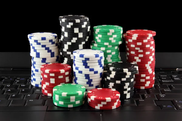 Stack of casino gambling chips on keyboard — Stock Photo, Image