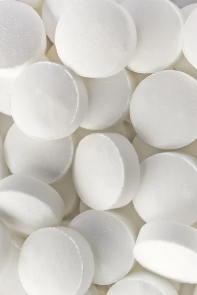 Pequenas pílulas brancas macro — Fotografia de Stock