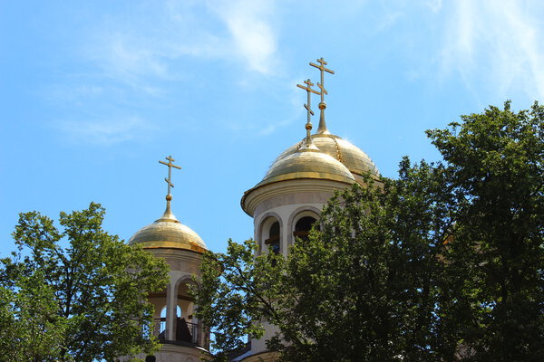 Russian golden domes of the temple against the blue sky.