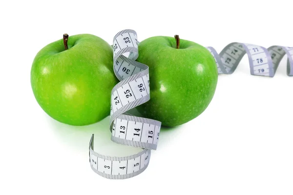 stock image Green apples with measurement tape on a white background