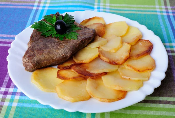 Veal with fried potatoes on a plate — Stock Photo, Image