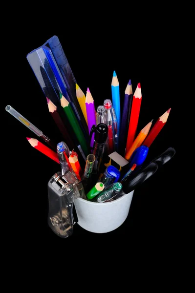 Pencils, pens, ruler, brush in a glass Stock Photo