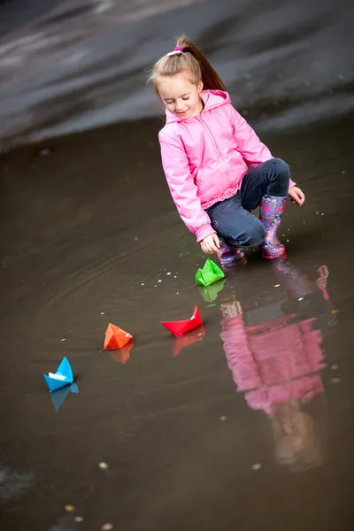 Girl playing in puddles — Stock Photo, Image