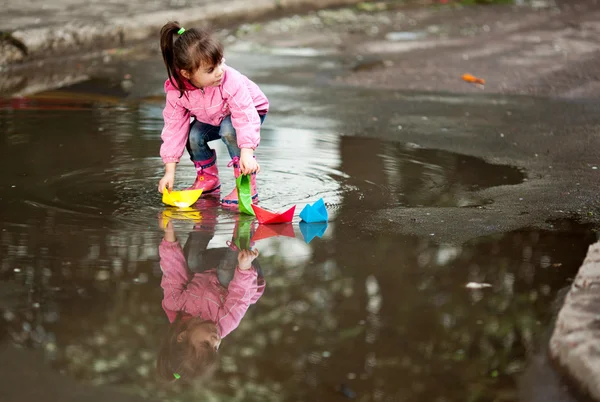 Stock image Girl playing in puddle