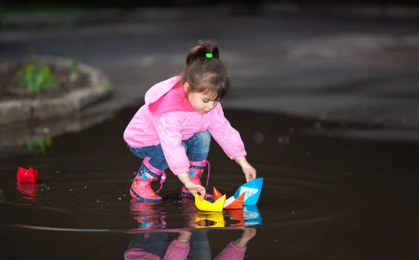 Girl playing in puddle Stock Photo