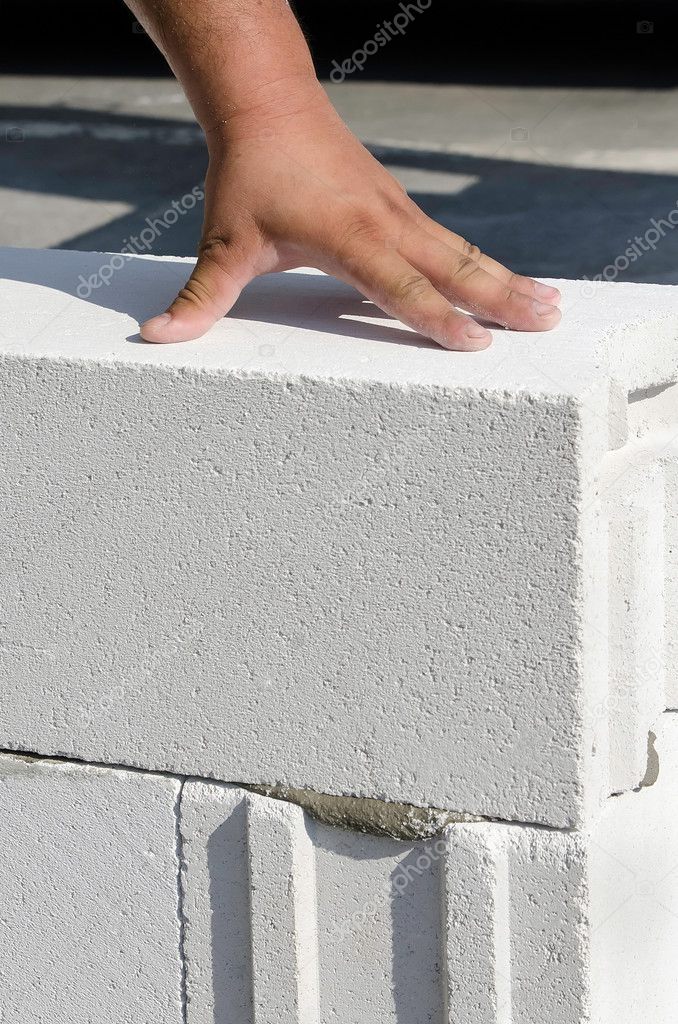 Mason working with construction blocks made from aerated concrete