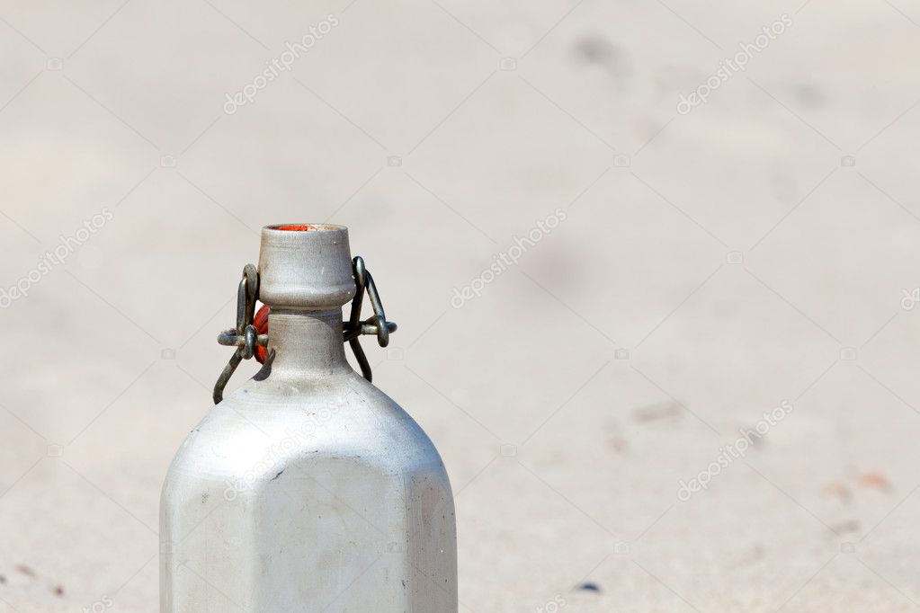 An empty canteen is in the desert sand Stock Photo by ©TKphotography