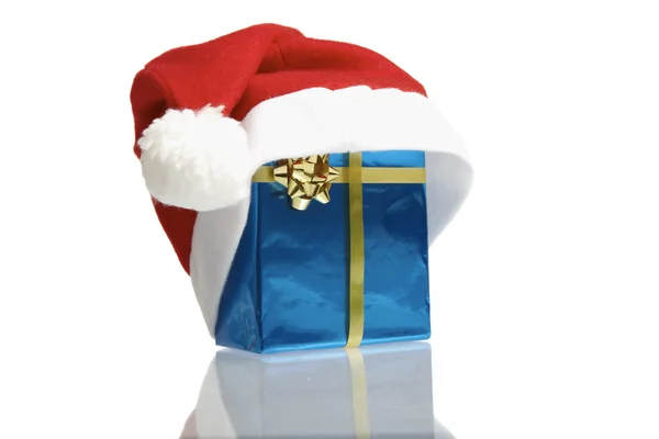 Santa claus cap and blue gift — Stock Photo, Image