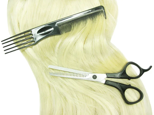 Hair brush and scissors in blond hair — Stock Photo, Image