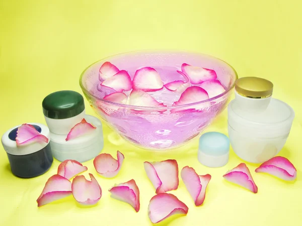 Spa bowl with rose petals and cremes — Stock Photo, Image