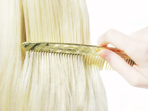 Hair brush with blond hair in it