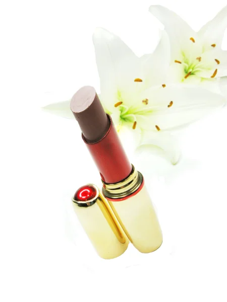 Red lipstick with lilies on background — Stock Photo, Image