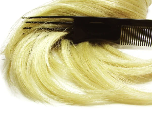 Hair brush with blond hair in it — Stock Photo, Image