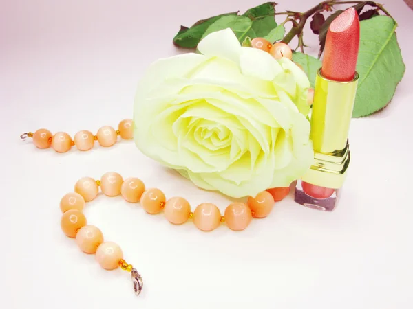 stock image Pink lipstick with rose on background