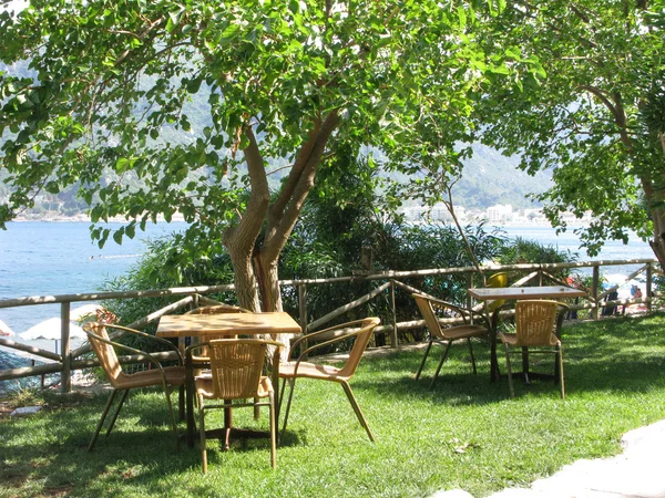 Kawiarnia w pobliżu morza komfortowe stoły i krzesła — Zdjęcie stockowe