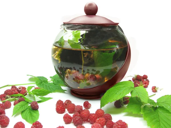 Teapot among fresh raspberry — Stock Photo, Image