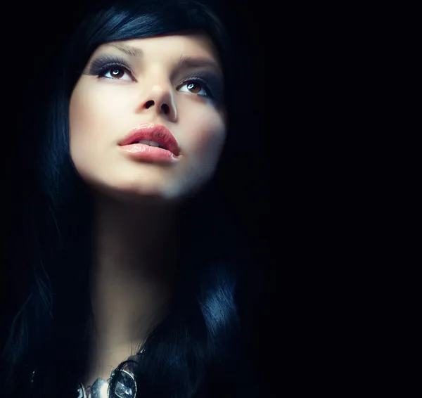 Beautiful Brunette Girl over Black Background. Darkness — Stockfoto