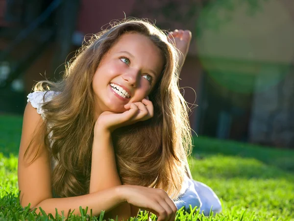 Mooi meisje liggend op het veld. geluk — Stockfoto