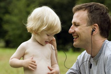 Father and the son listen to music clipart