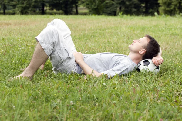 Stock image The young man has a rest after game in football