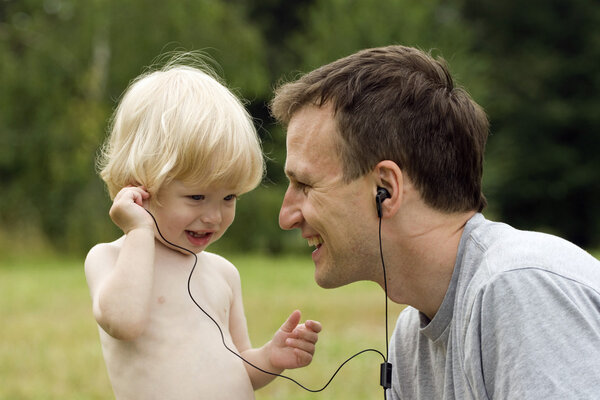 Happy father and the son listen to music