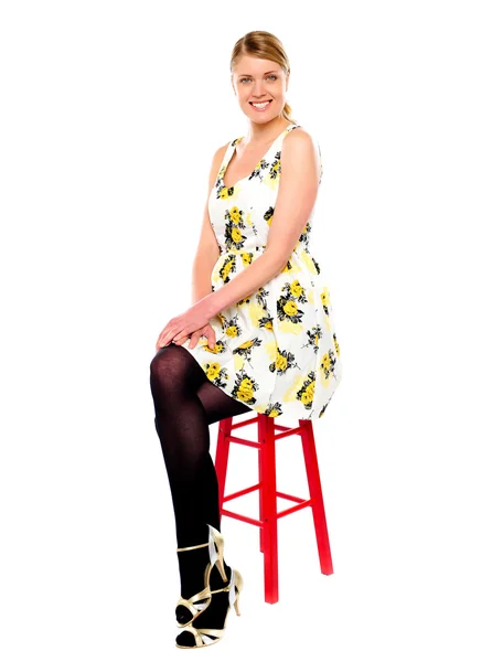 Glamourous woman sitting on stool — Stock Photo, Image